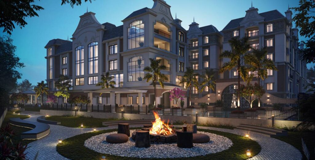 Evening view of GK Raj CasaGrande apartments with fire pit and landscaped garden in Yapral, Secunderabad